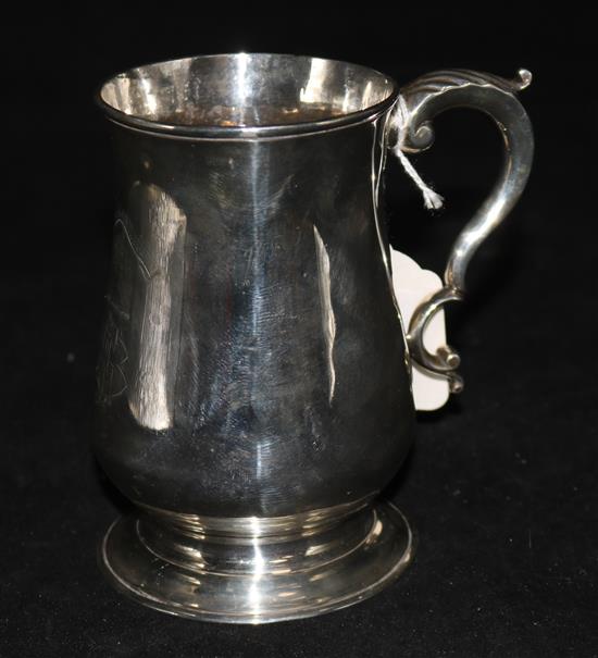 A George III silver mug, of baluster form with acanthus decorated C-scroll handle, London 1777, maker IK (probably John King)